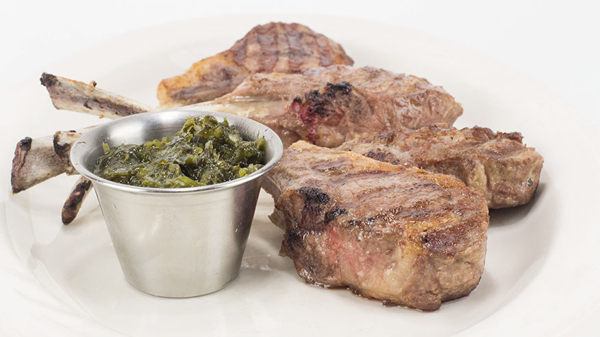 Grilled lamb chops on the bone served with mint.